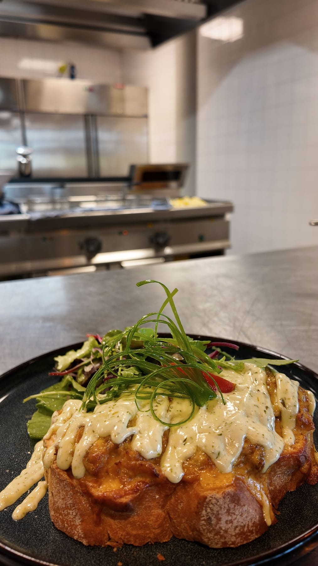 Gegratineerde toast met gesmolten cheddar, kruidensaus en knapperige prei