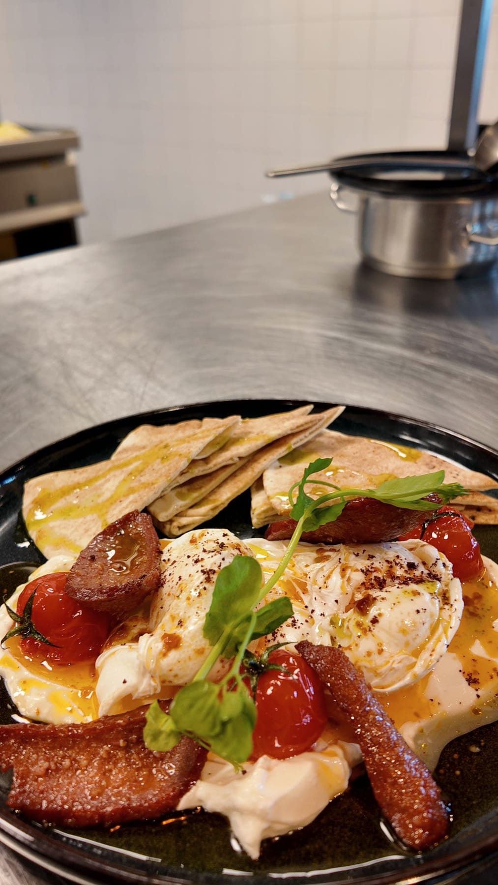 Turkish Sunrise: gepocheerde eieren op romige labne met merguez, gepofte tomaatjes en platbrood